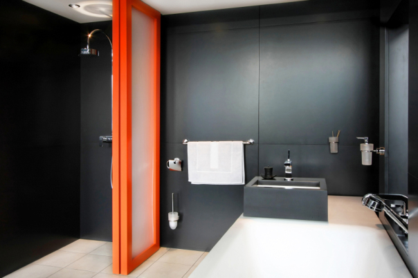 Bathroom all in black with orange divider