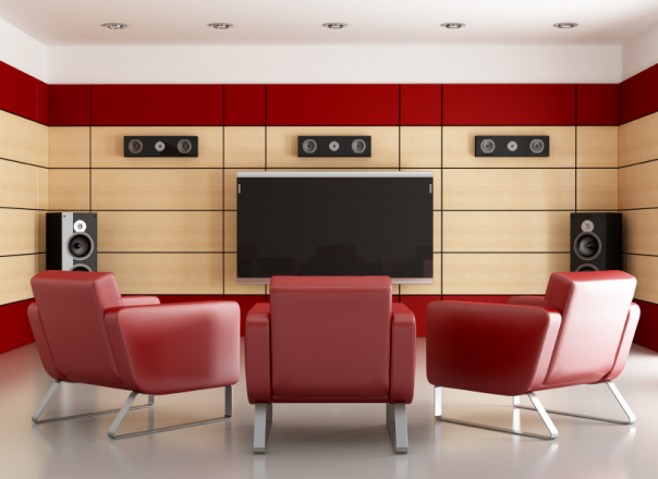 Home media room with wood panels and 3 red armchairs