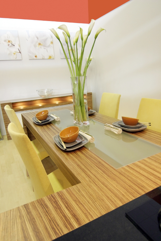 Modern dining room featuring white and red walls and built-in wood eating area