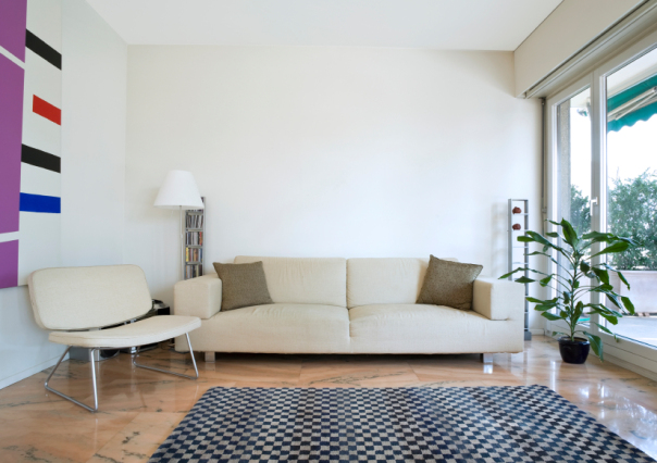 living room with white walls and beige modern furniture