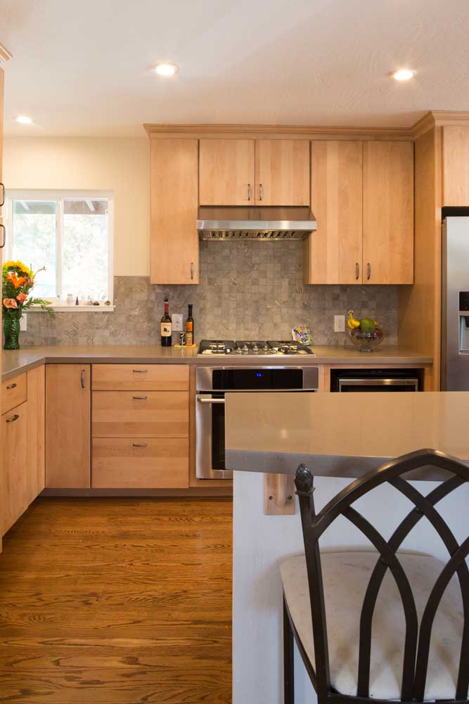 Contemporary kitchen with warm wood cabinets and wood floor