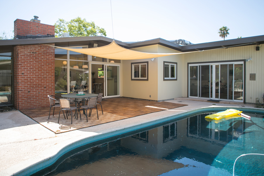 Backyard of mid-century modern home with pool