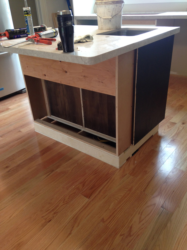 Paritally built kitchen island with tools and paint bucket on top