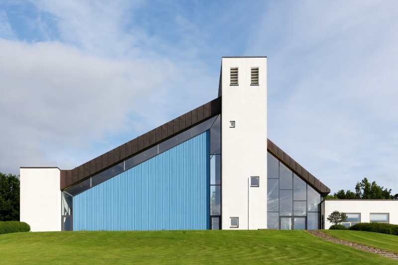 exterior of modern church with scalloped glass wall
