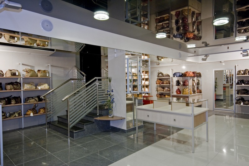 interior of modern retail shop displaying handbags