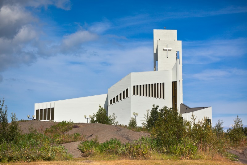 exterior of white modern church on hill