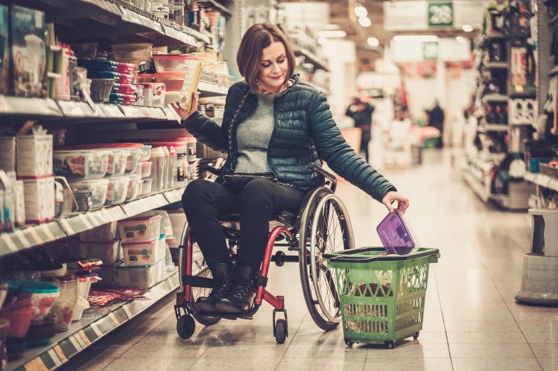 Woman using wheelchair shopping