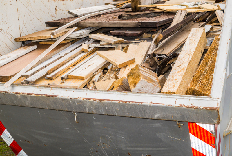 Garbage container with broken wood pieces