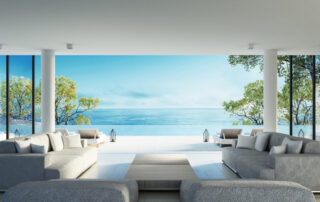 Modern living room with open wall to a sunny beach