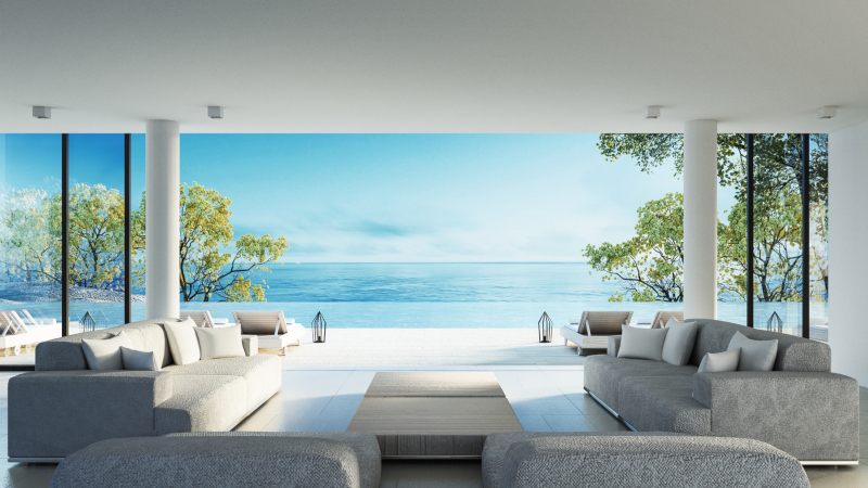 Modern living room with open wall to a sunny beach