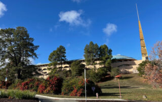 Marin County Civic Center. Modern, beige building with blue tile roof nestled among gentle hills