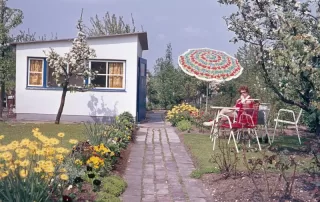 Small backyard accessory dwelling unit witth garden and brick path.