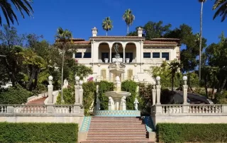 Exterior of Casa del Sol, a Spanish-Revival-style building with tile steps leading to the building entrance